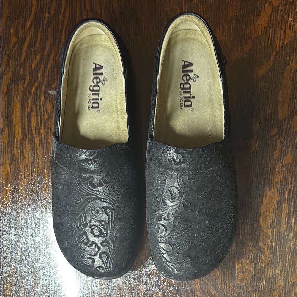 Alegria Black Embossed Slip-On Shoes